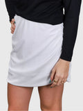 Close-up of white Airy Twist Skort by MUEV with subtle ruching, designed for padel and pickleball clothing
