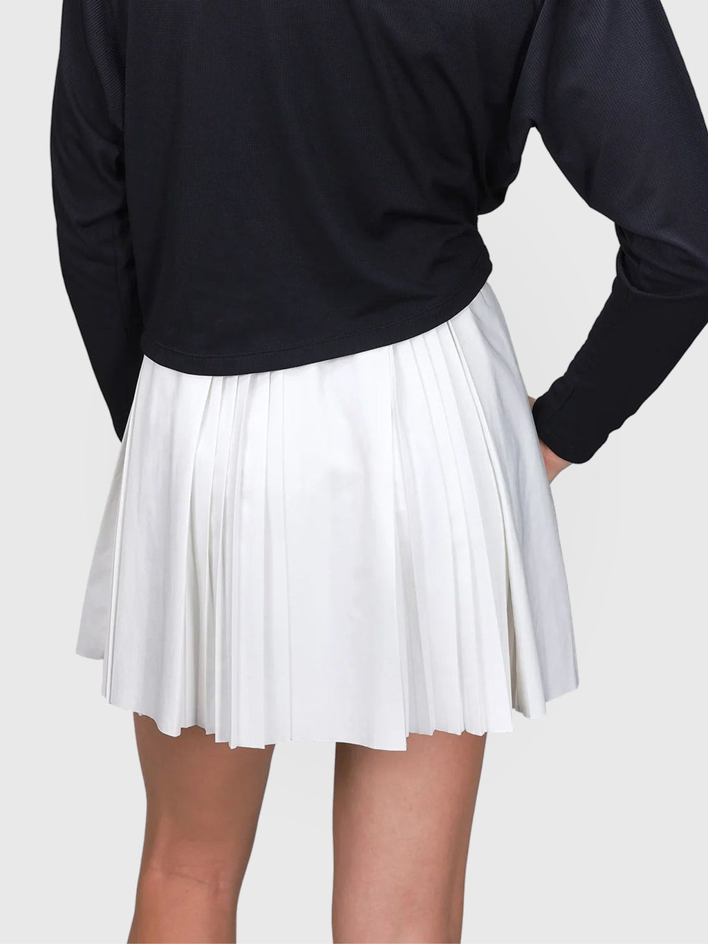 Back view of white Flutter Skort by MUEV featuring pleated design for padel and pickleball clothing