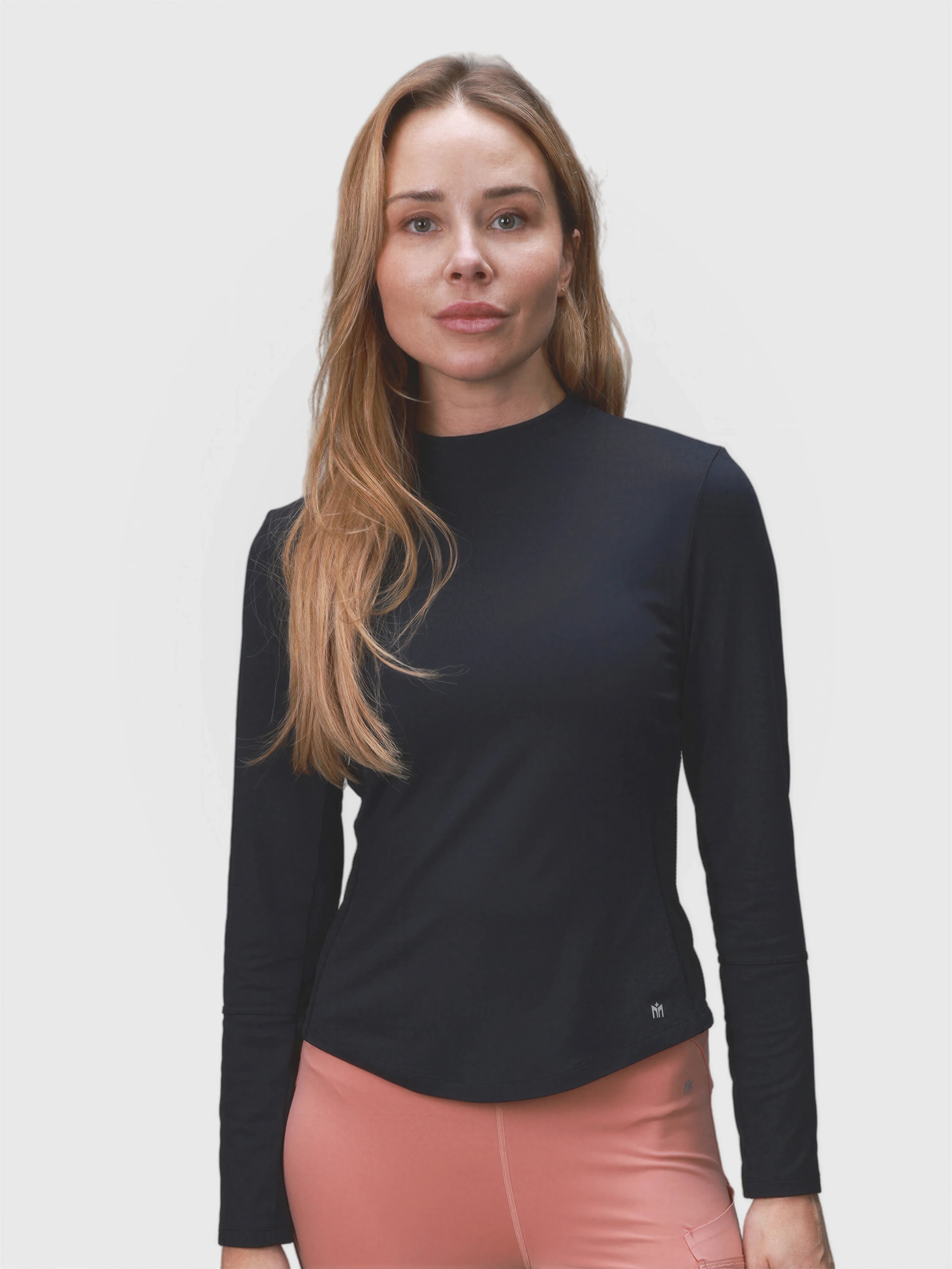 Woman modeling black AirForm Mesh Back Long Sleeve by MUEV, designed for padel and pickleball apparel