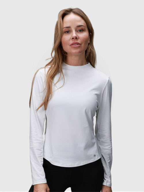 Woman wearing white AirForm Mesh Back Long Sleeve by MUEV designed for padel and pickleball clothing