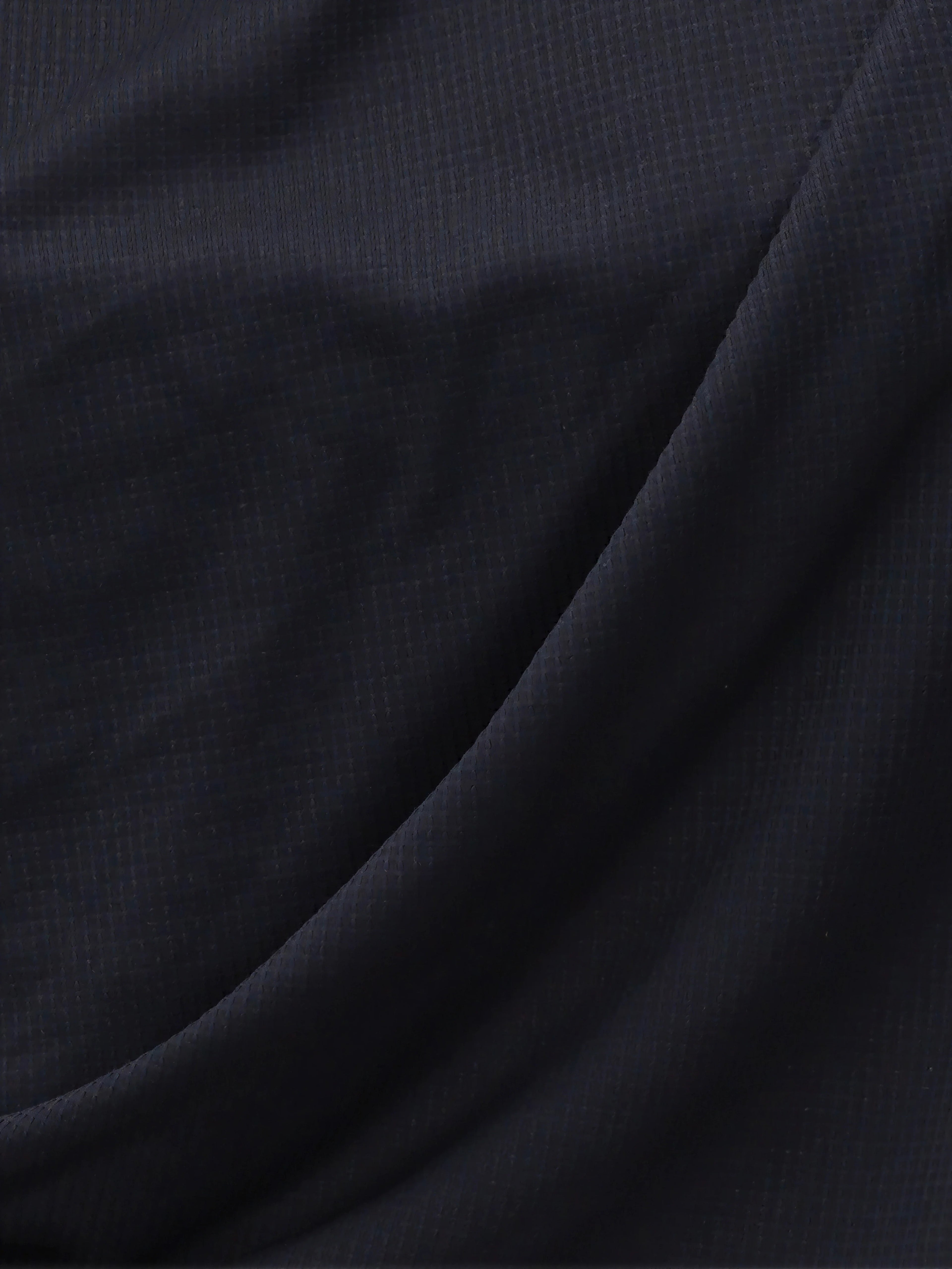 Close-up of black Airy Twist Long Sleeve fabric texture by MUEV for padel and pickleball apparel