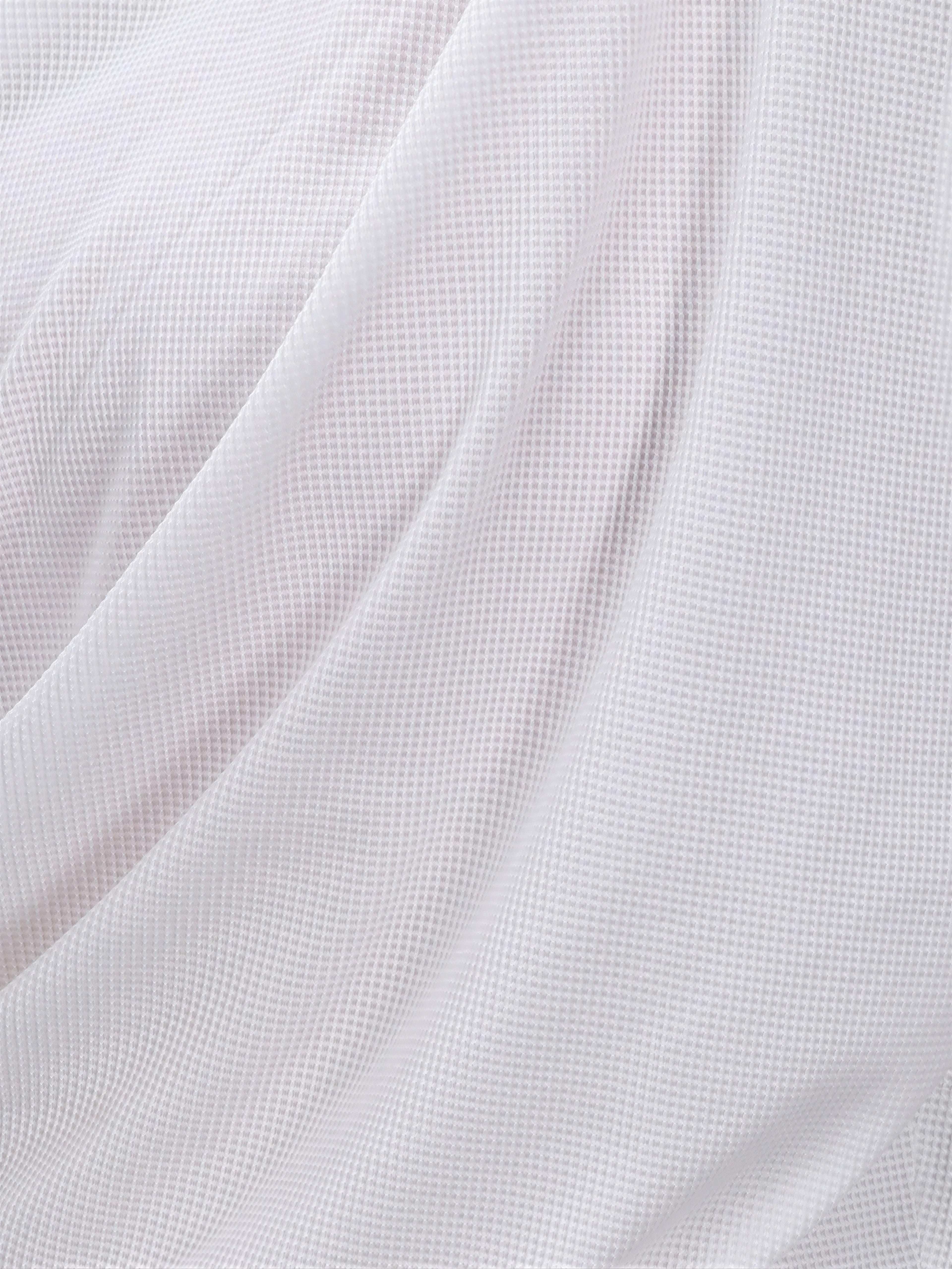 Close-up of white Airy Twist Long Sleeve fabric texture by MUEV for pickleball and padel clothing