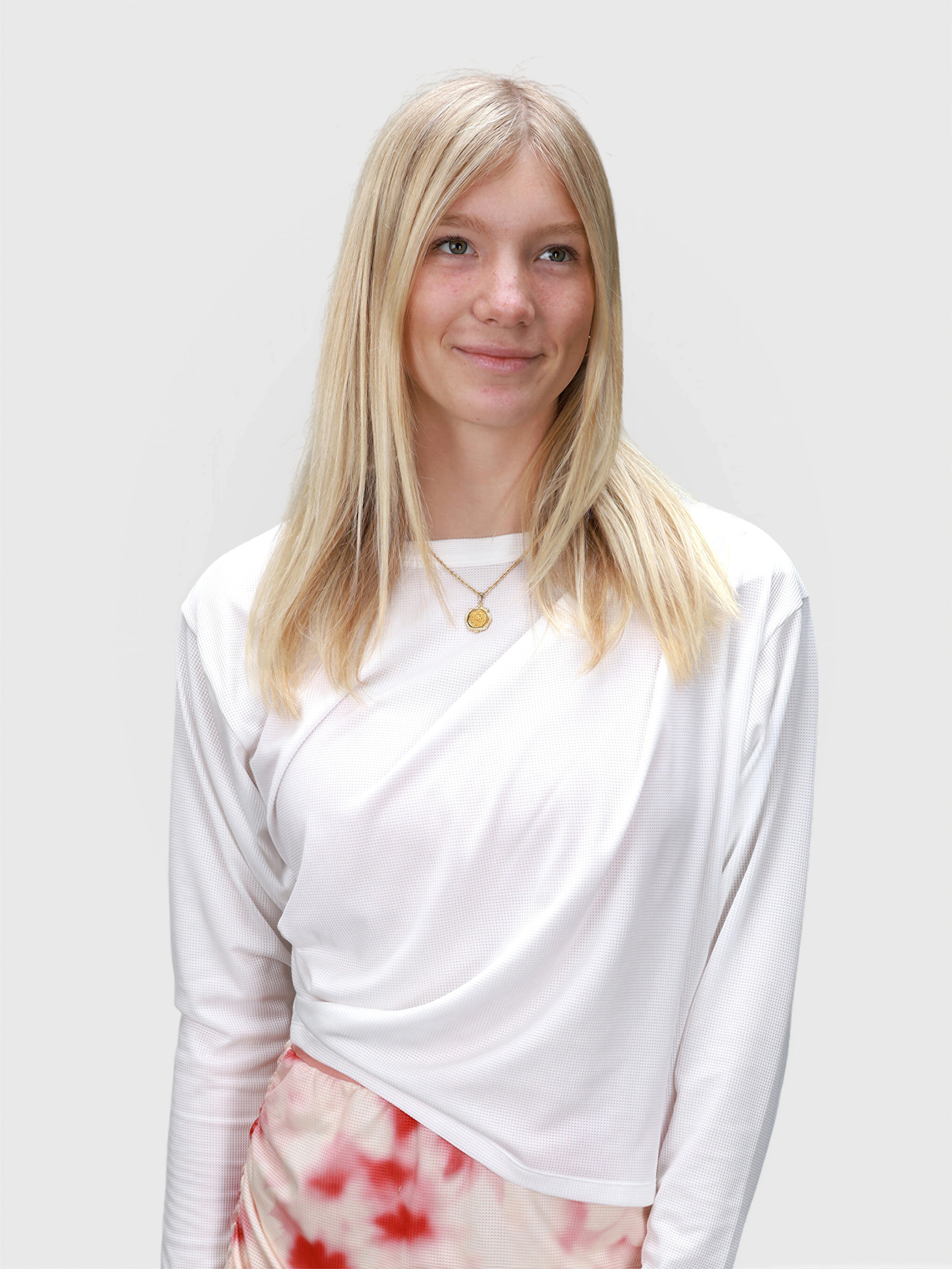 Woman wearing white Airy Twist Long Sleeve by MUEV styled for padel and pickleball clothing