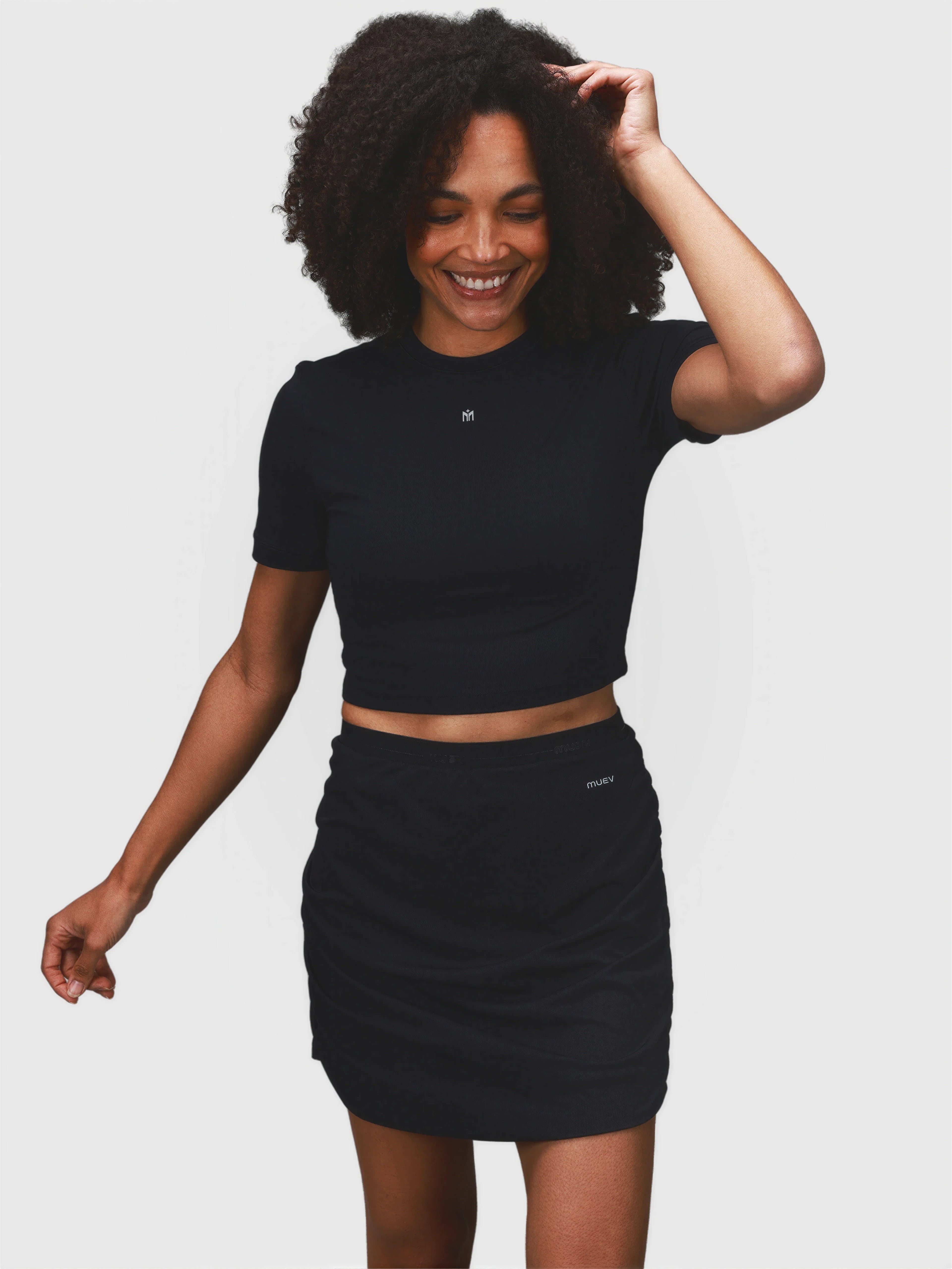 Model wearing black Airy Twist Skort and matching top by MUEV designed for padel and pickleball clothing