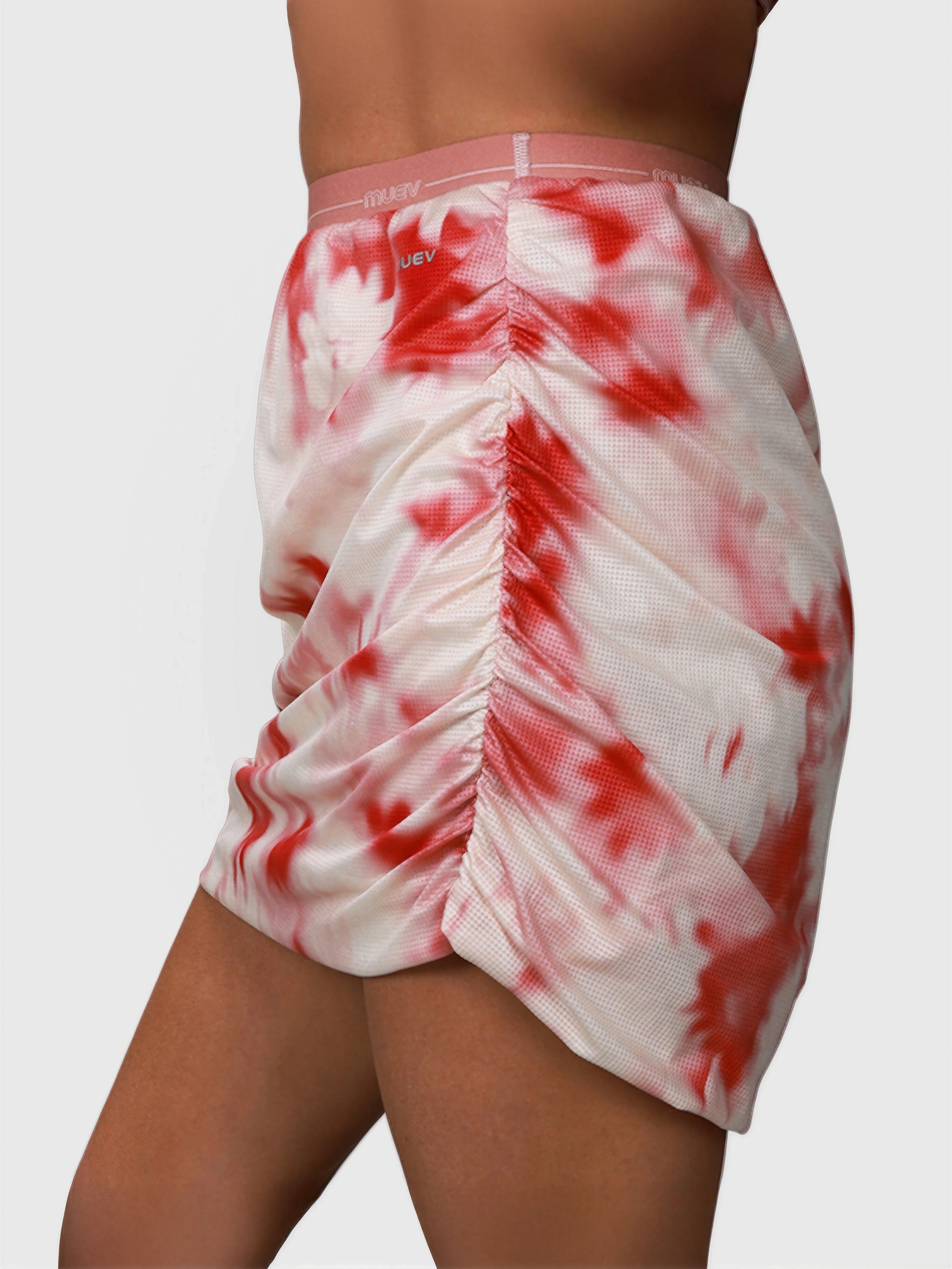 Side view of pink petal Airy Twist Skort by MUEV with ruched detail designed for pickleball and padel apparel