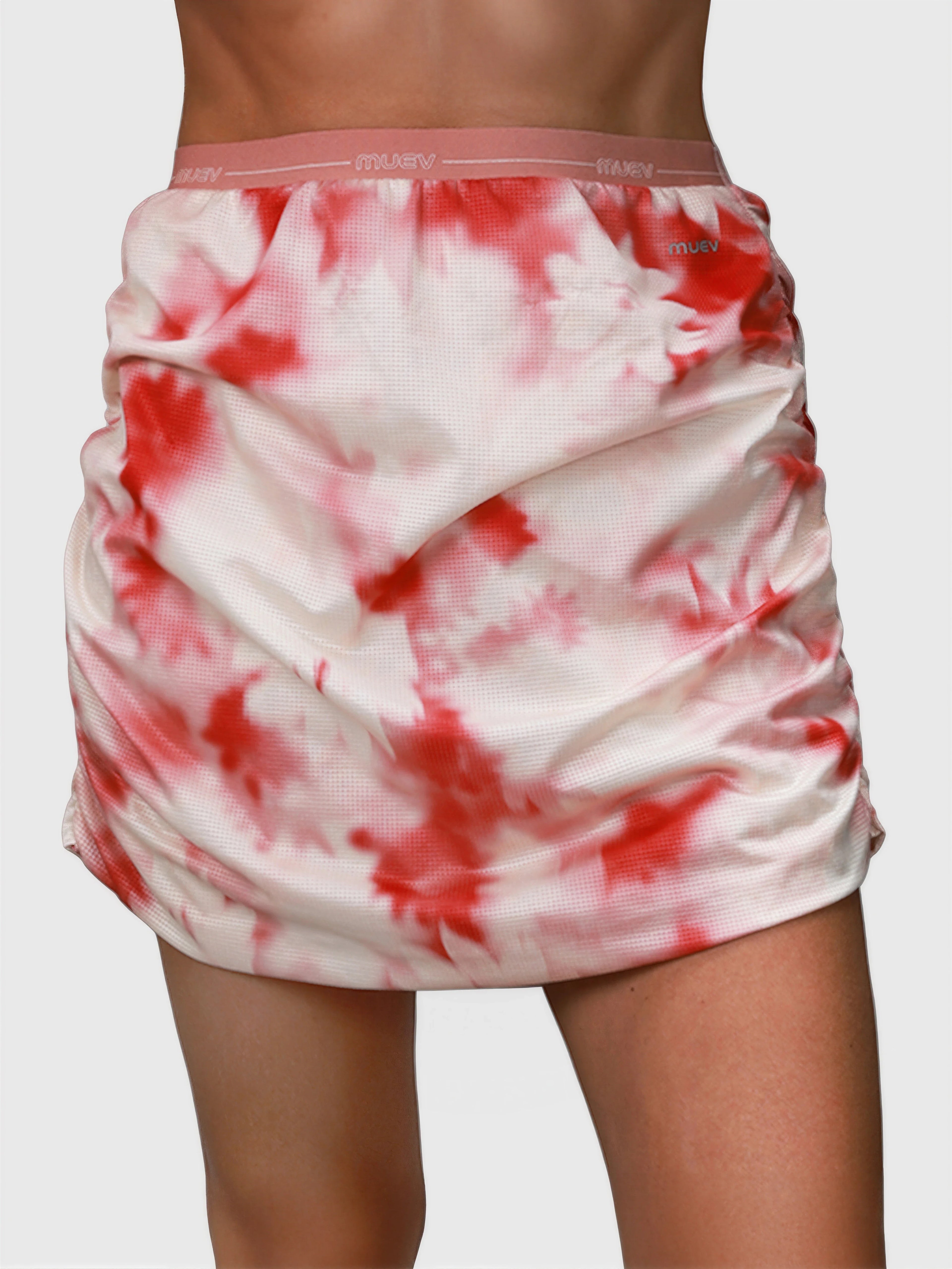 Front view of pink petal Airy Twist Skort by MUEV designed for pickleball and padel clothing with ruched sides