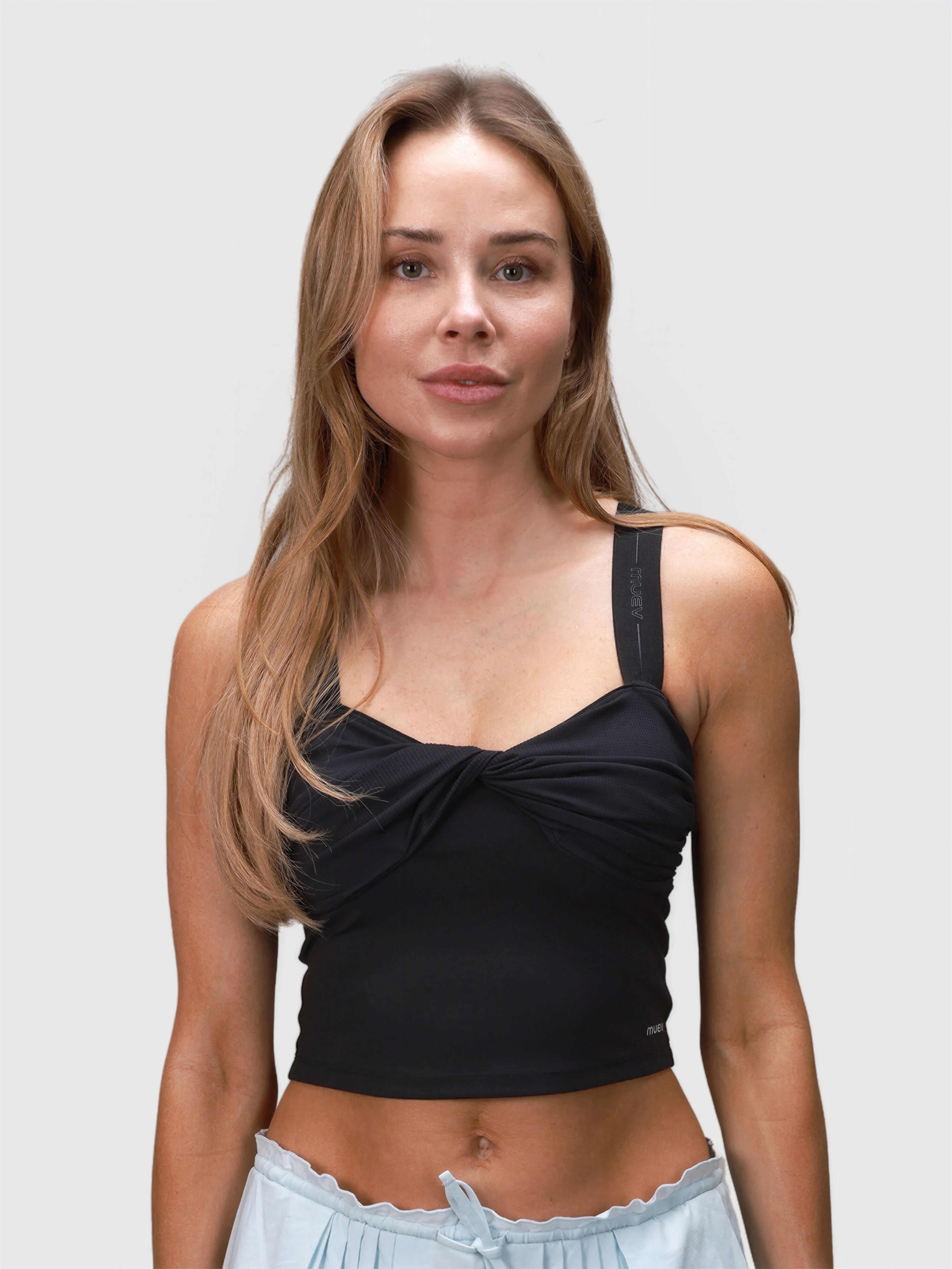 Front view of woman wearing black Airy Twist Tank by MUEV designed for padel and pickleball apparel