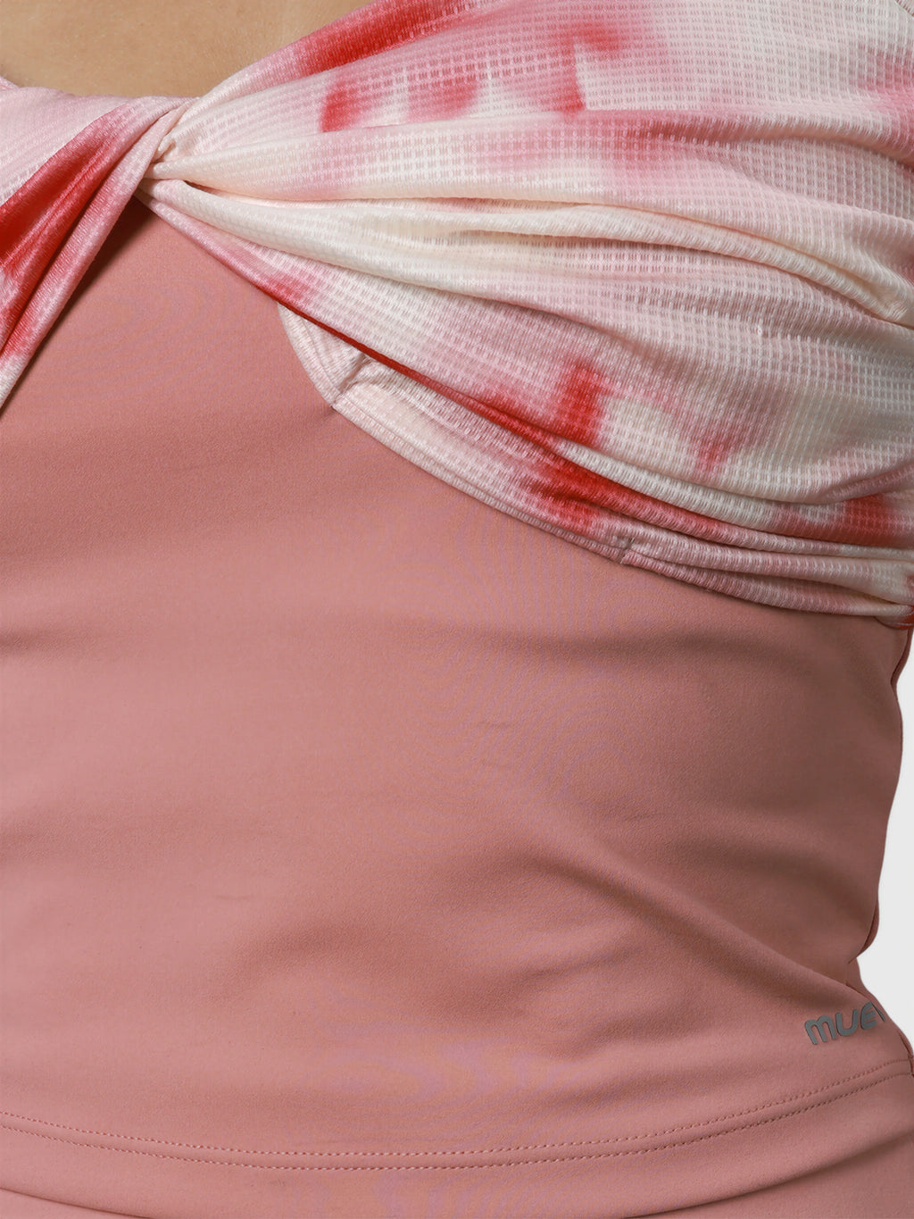 Close-up of pink petal Airy Twist Tank by MUEV showing twist detail for padel and pickleball clothing