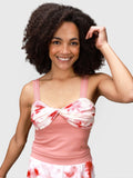 Woman wearing pink petal Airy Twist Tank by MUEV designed for padel and pickleball clothing
