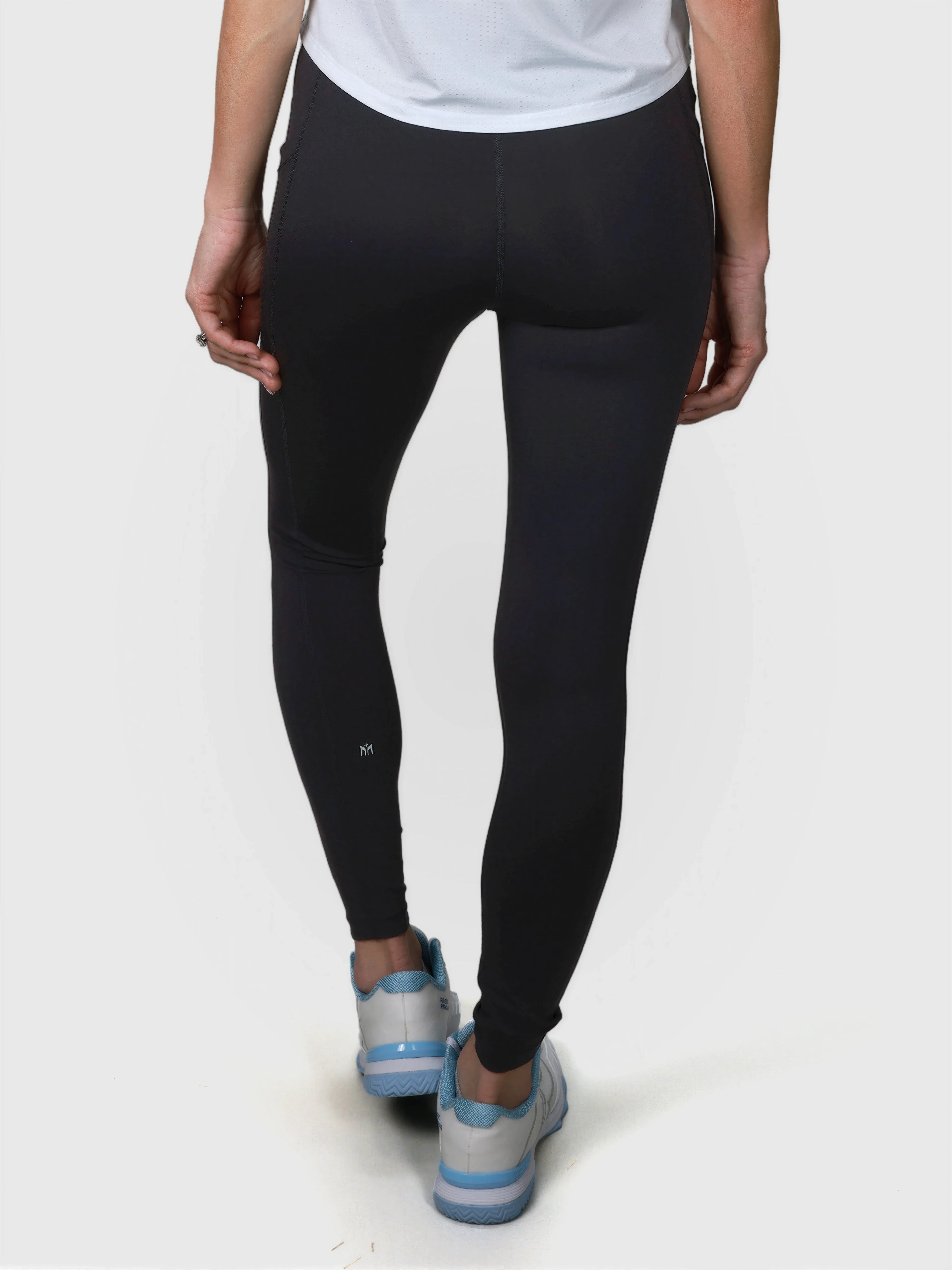 Rear view of black V Cross Over Leggings by MUEV designed as padel and pickleball apparel with a high waist fit