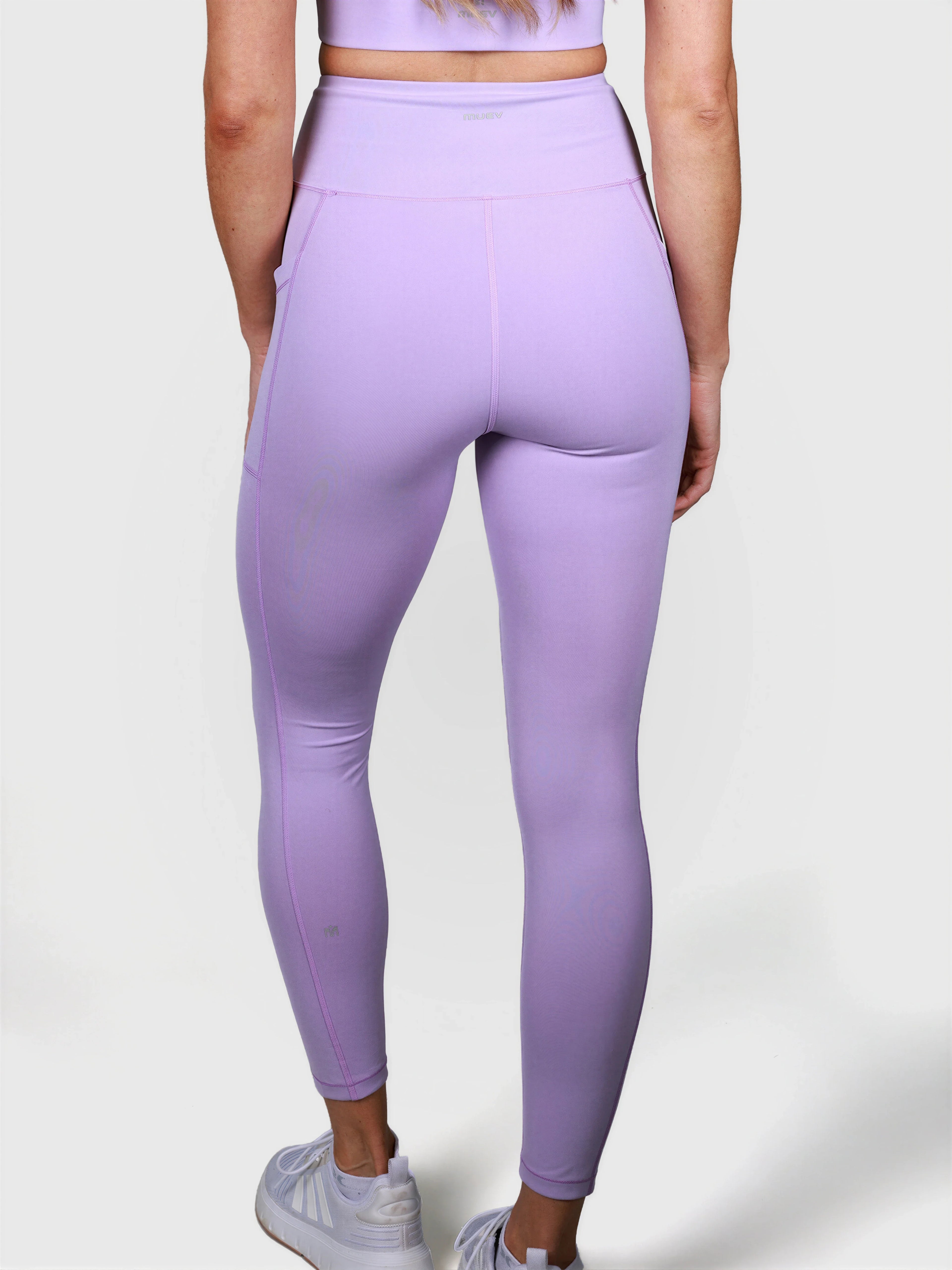rear view of woman wearing lavender V Cross Over Leggings by MUEV for padel and pickleball apparel