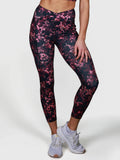 woman wearing pink and black patterned V Cross Over Leggings by MUEV for padel and pickleball apparel