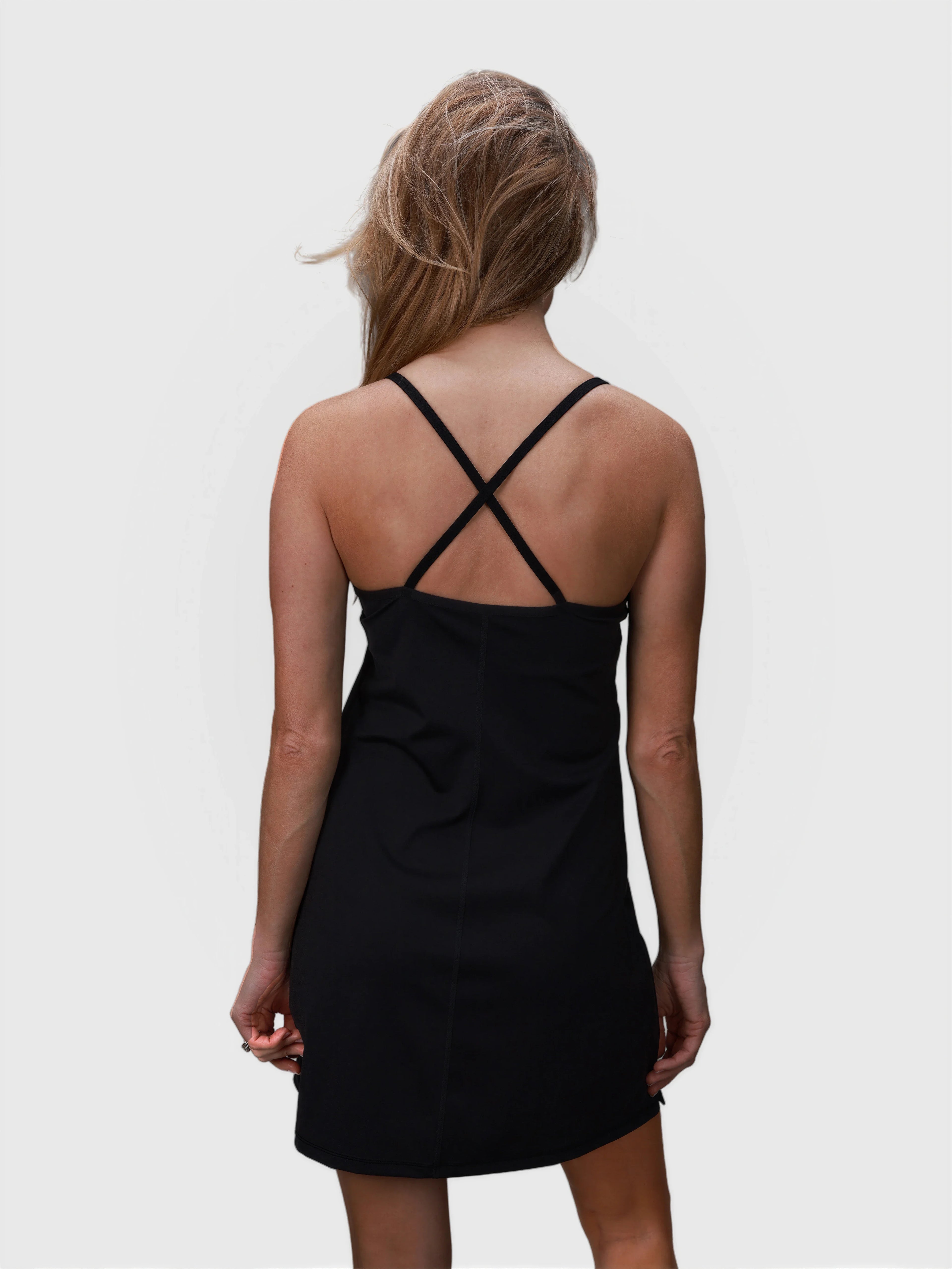 Rear view of black Double V Dress by MUEV with crossed straps designed for padel and pickleball clothing