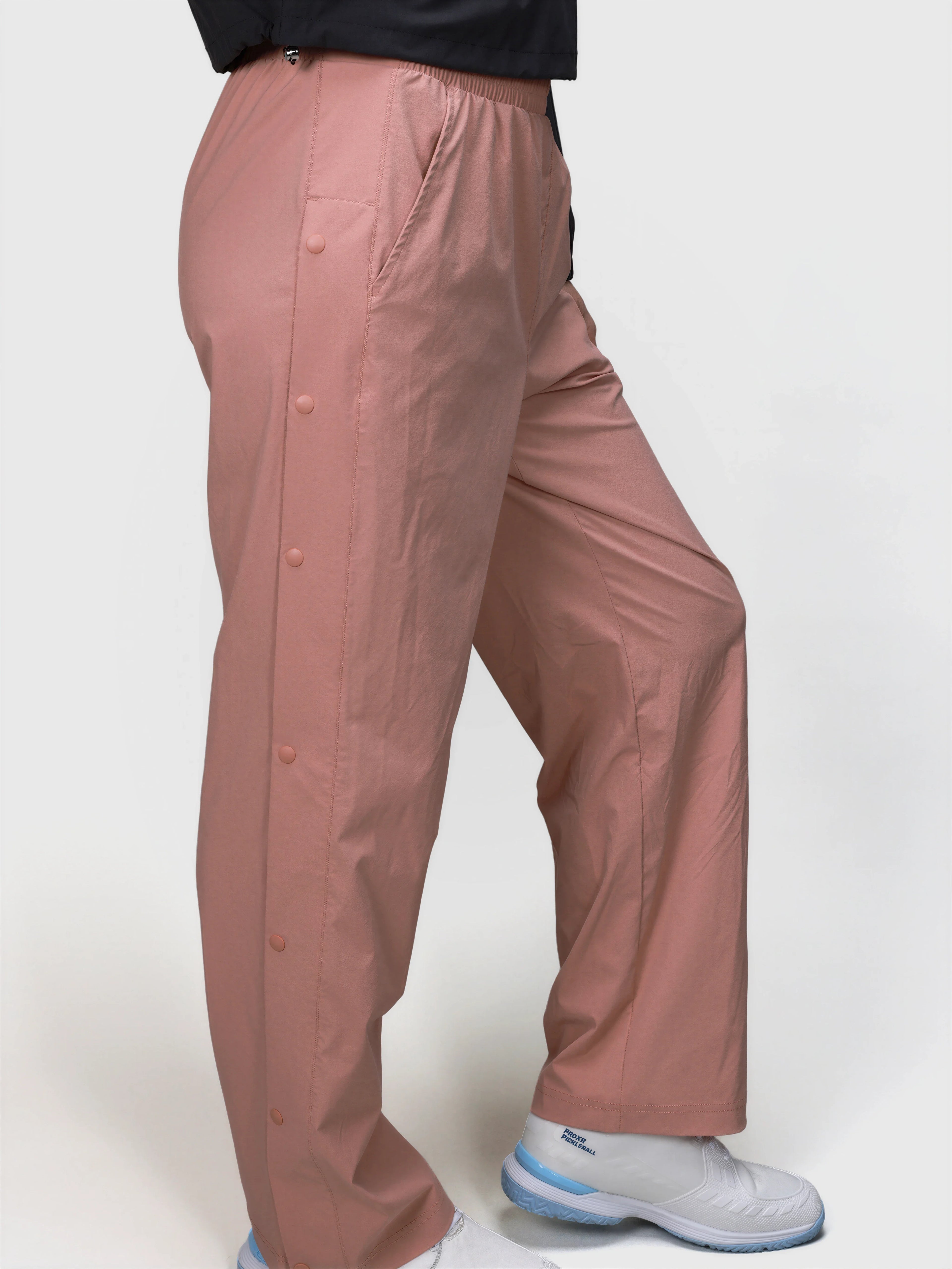 Side view of person wearing dusty pink E Sas Tear Away Pant by MUEV with elastic waistband for pickleball clothing