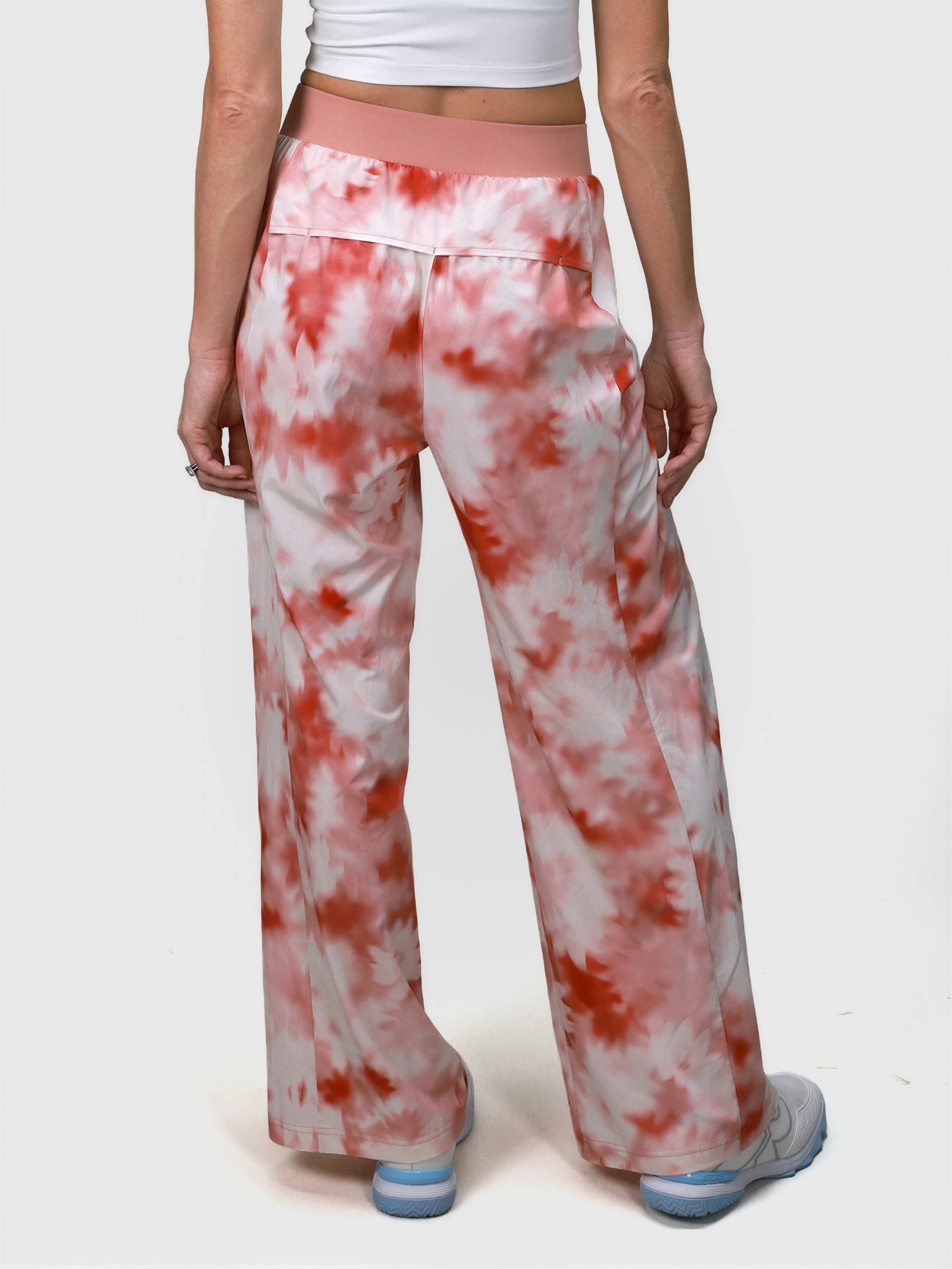 Rear view of pink petal Grace Pleated Pant by MUEV with wide legs and elastic waistband for padel apparel