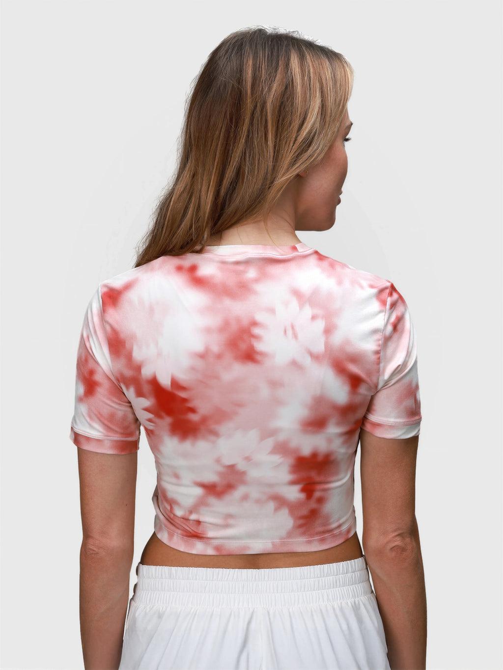 Rear view of pink petal Kamryn Cropped Tee by MUEV for pickleball clothing with short sleeves and fitted cut