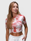Woman wearing pink petal tie-dye Kamryn Cropped Tee by MUEV styled for pickleball clothing