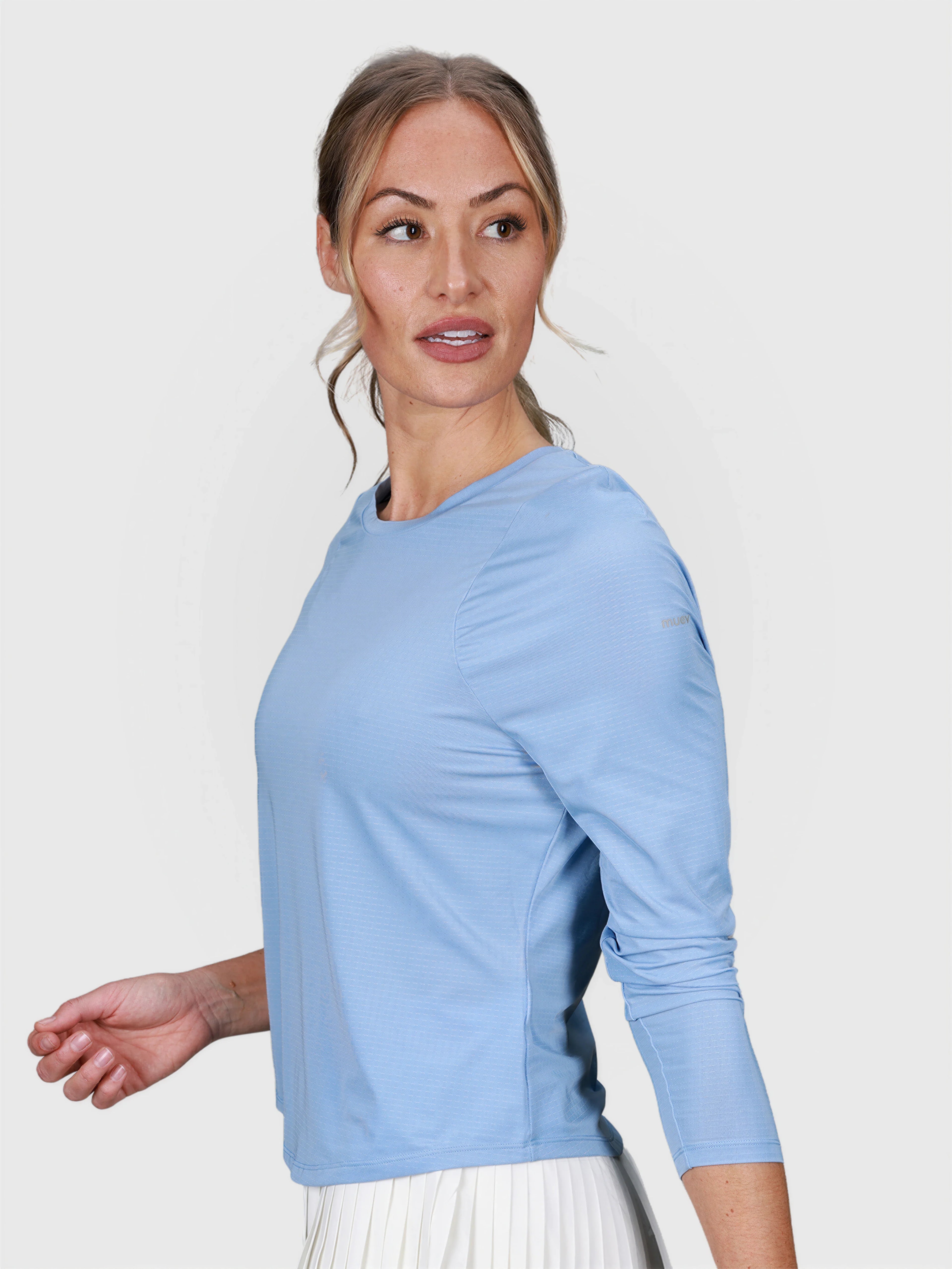woman wearing cloud blue Performance Long Sleeve top by MUEV for padel and pickleball apparel