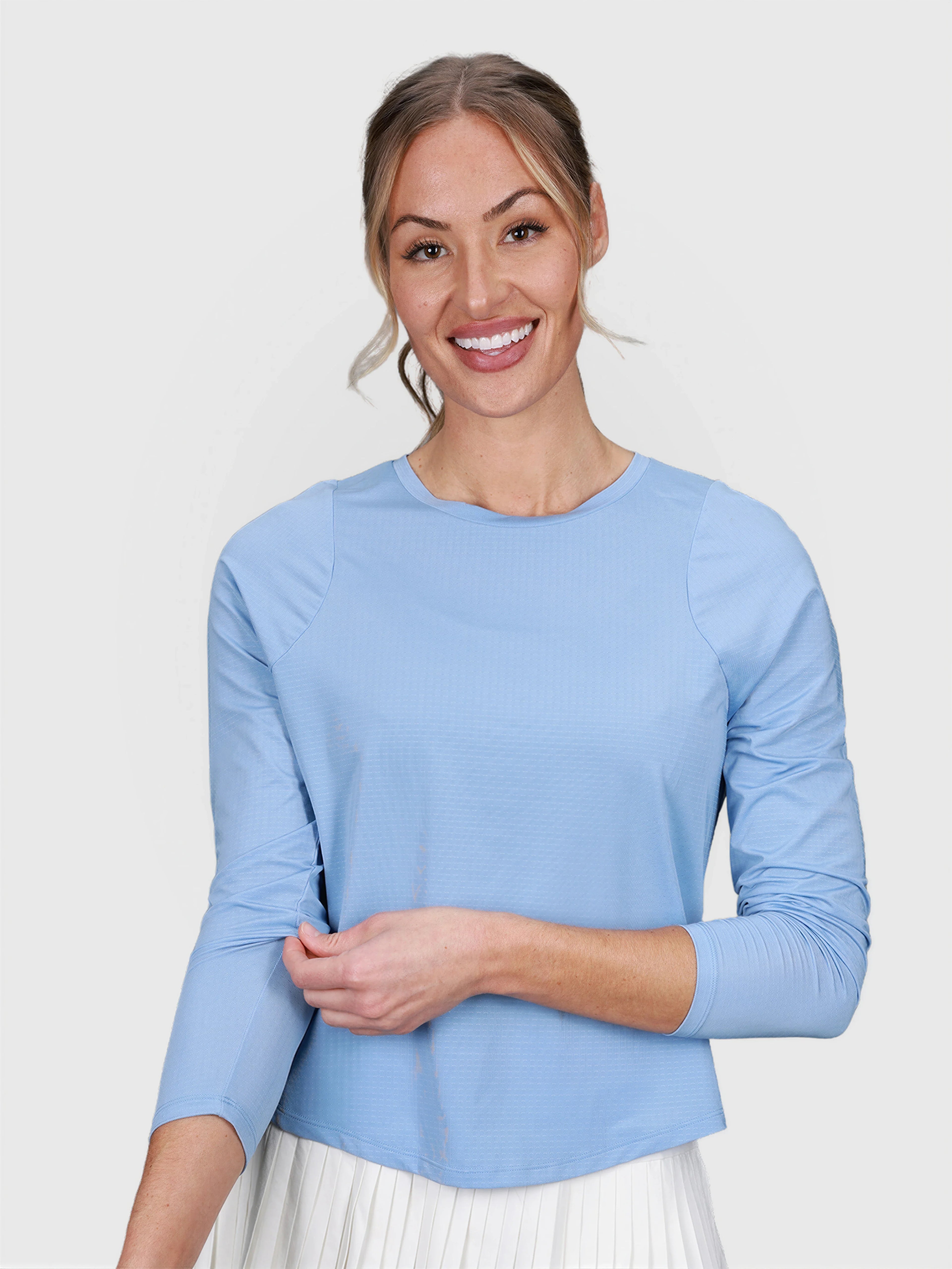 woman wearing cloud blue Performance Long Sleeve top by MUEV for padel and pickleball clothing