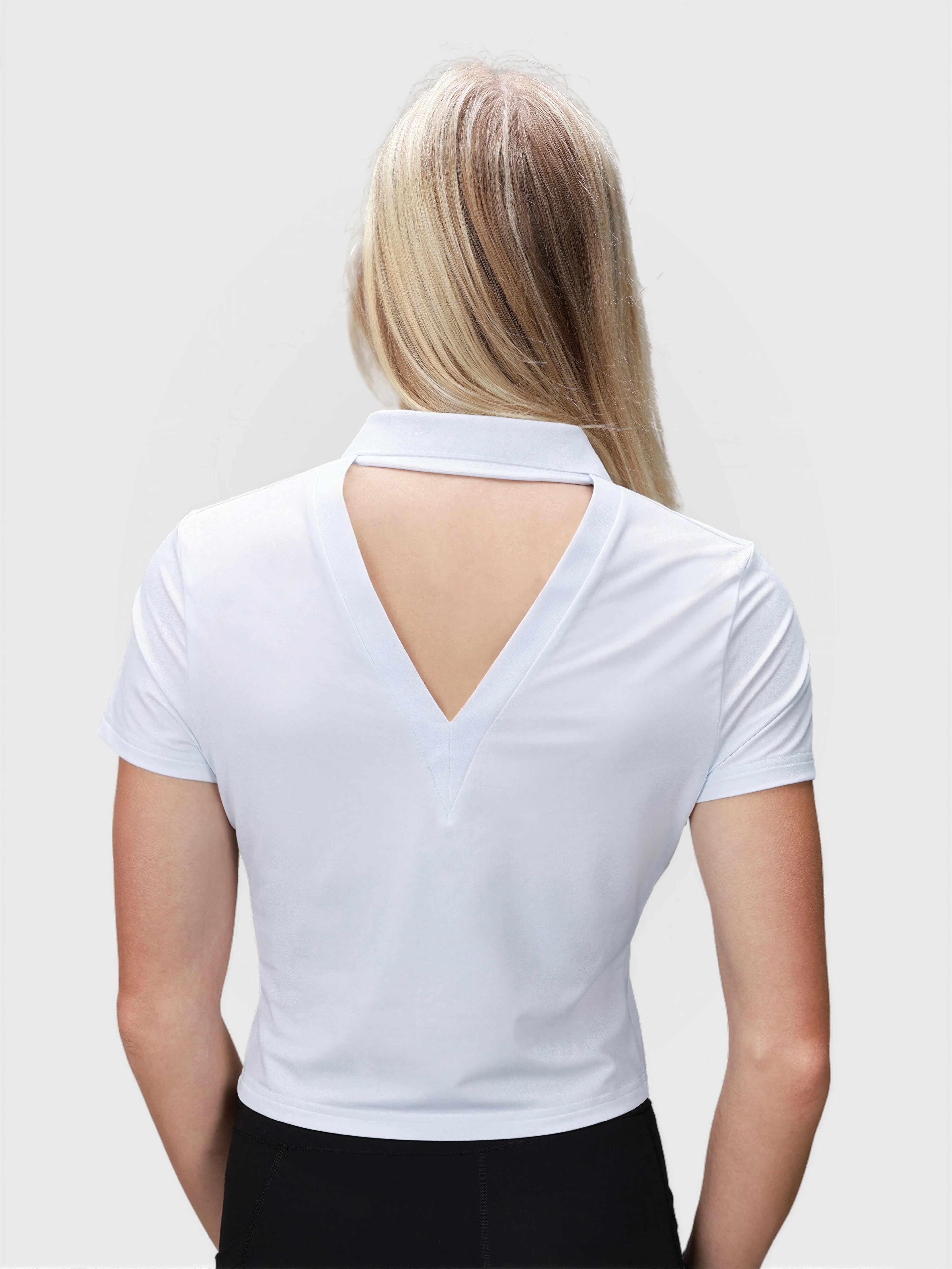 Back view of white Open Back Polo by MUEV featuring a triangular cutout, designed for padel and pickleball apparel