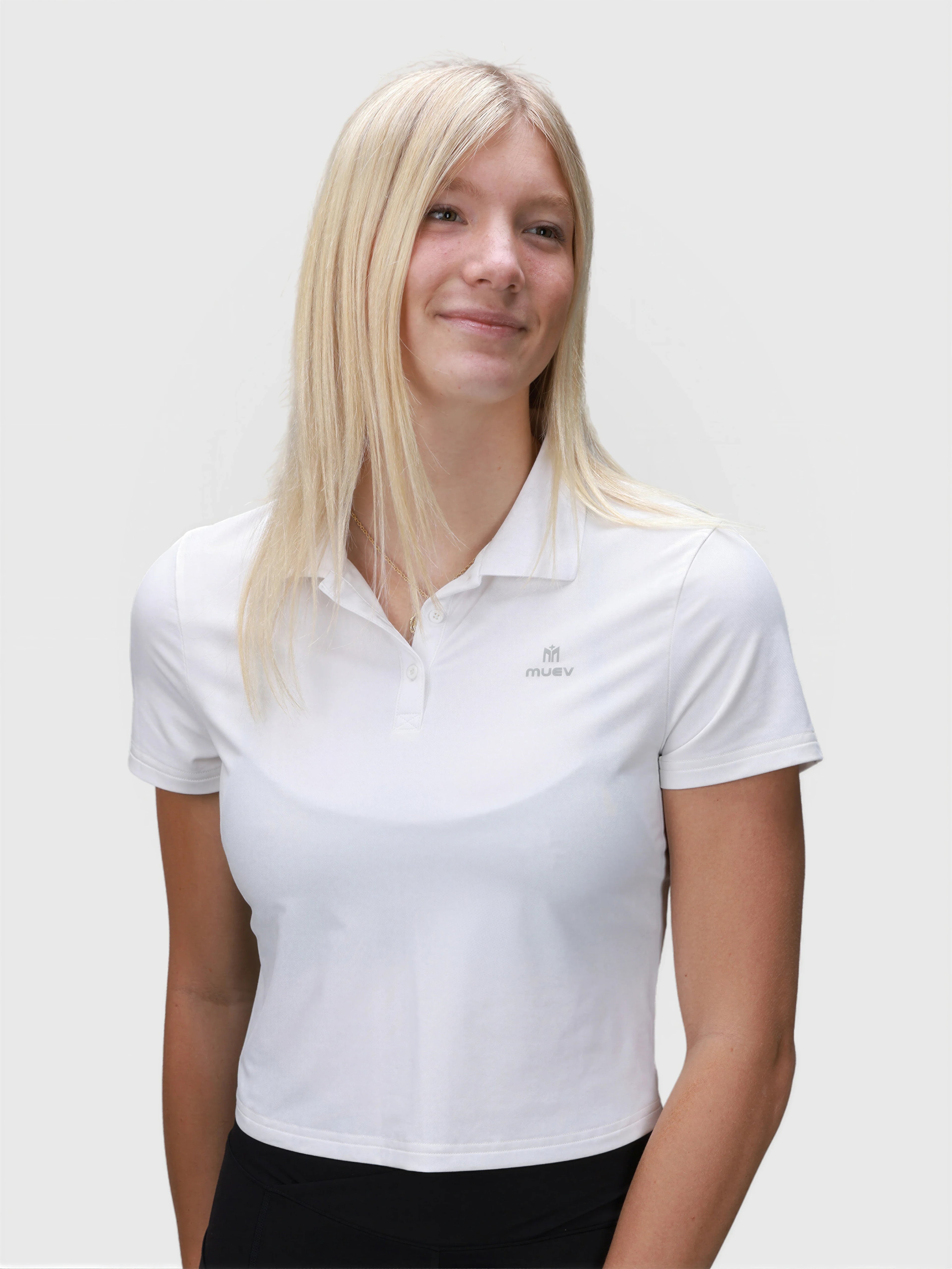 Woman wearing ice blue Open Back Polo by MUEV designed for pickleball and padel apparel with classic collar and short sleeves