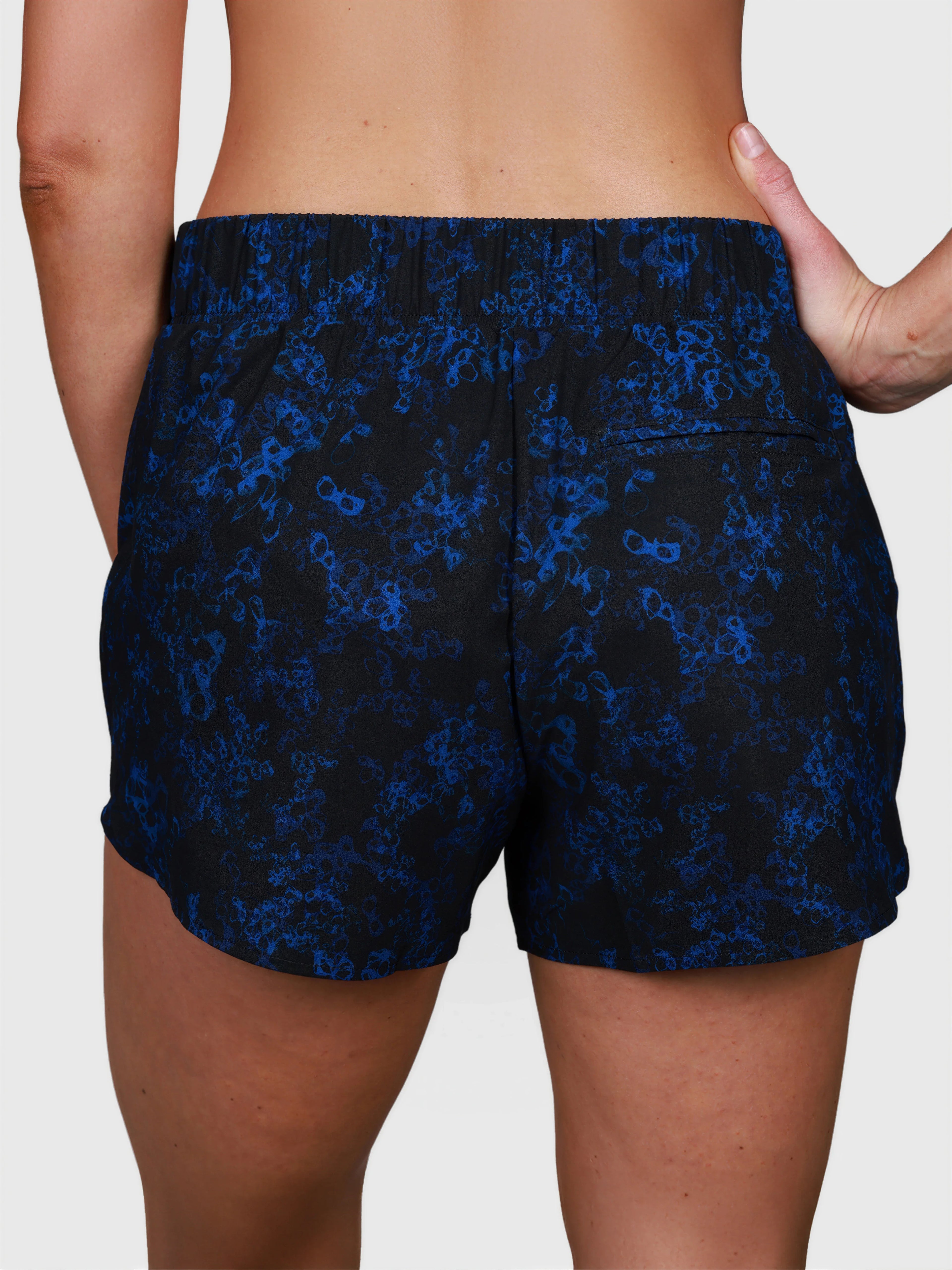 back view of blue sakura patterned Performance Short by MUEV designed for padel and pickleball apparel