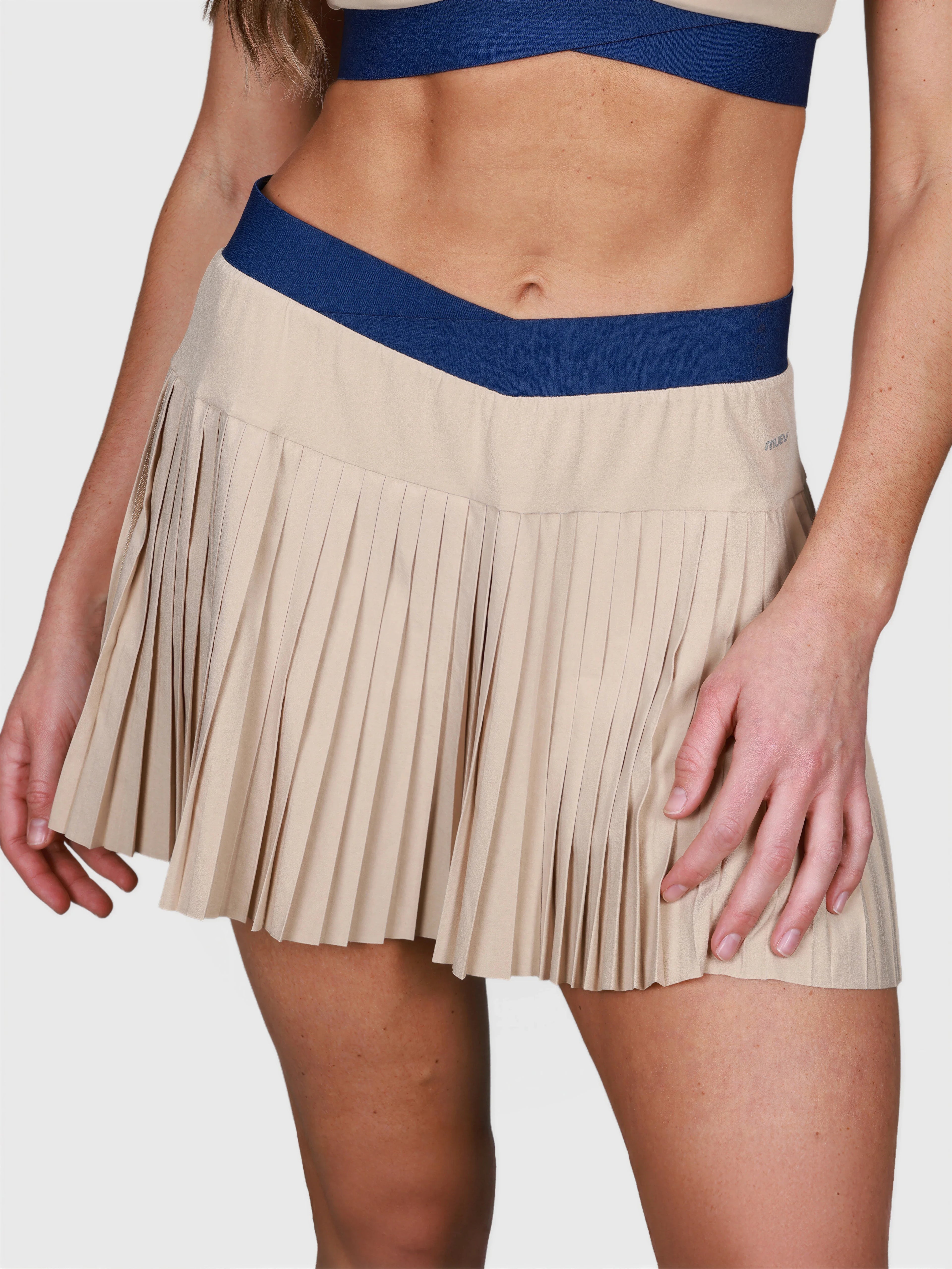 close-up front view of khaki Performance Pleated Skort with navy waistband by MUEV for padel and pickleball clothing