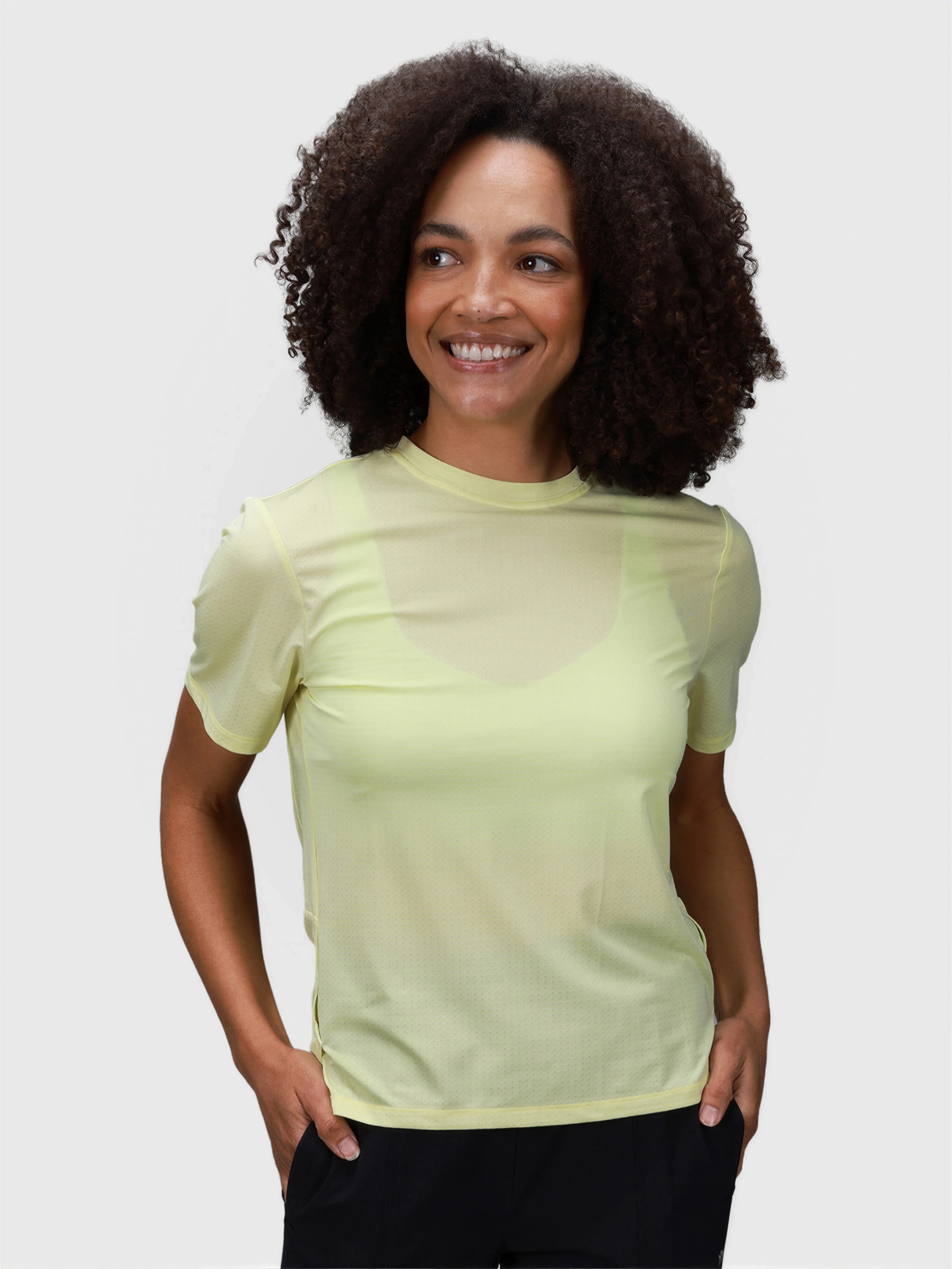 Woman wearing citron PowerMove Performance Tee by MUEV styled for padel and pickleball clothing