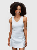 Woman modeling white Power Performance Dress by MUEV designed for pickleball and padel apparel