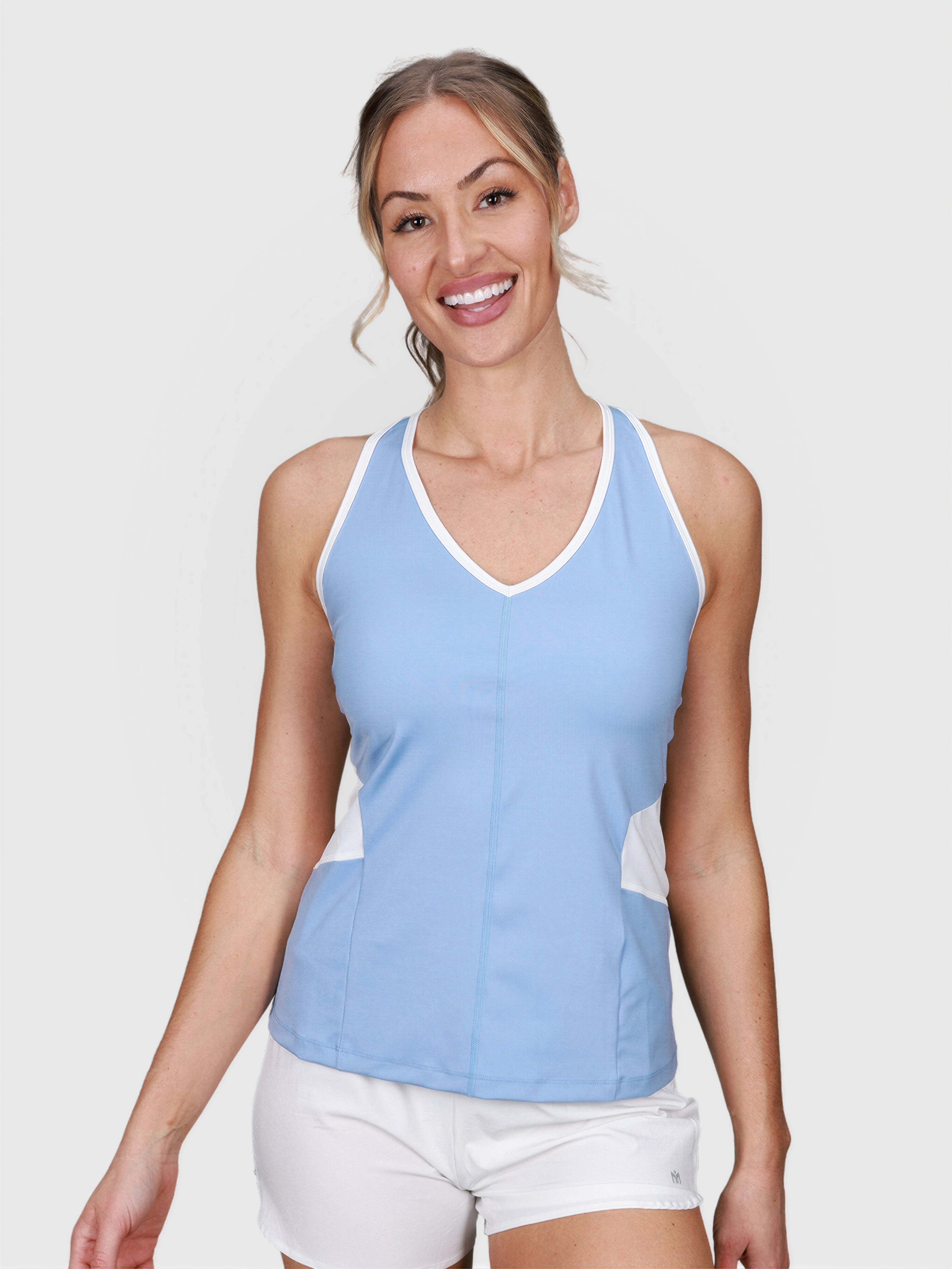front view of woman wearing cloud blue Racerback Tank by MUEV for padel and pickleball apparel