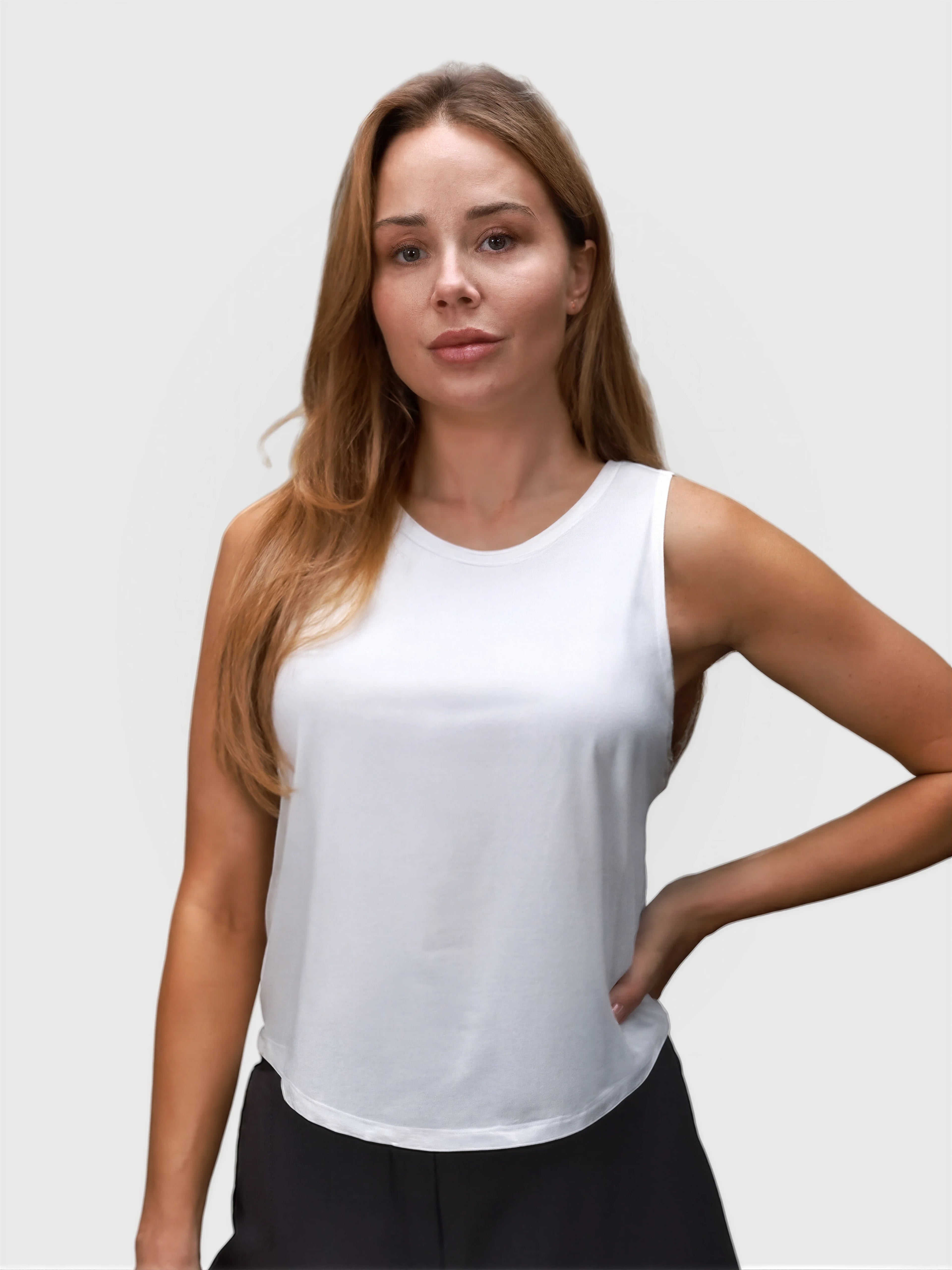 Woman wearing white Relaxed Tank by MUEV designed for padel and pickleball apparel