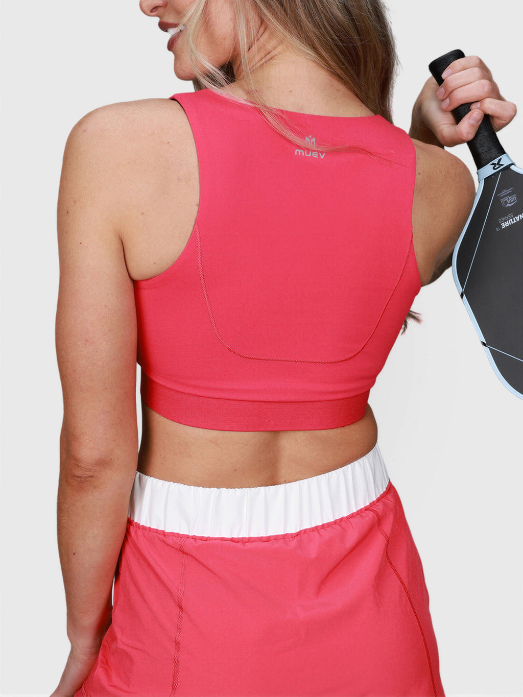 rear view of woman wearing pink V Neck Tanklette Crop by MUEV for padel and pickleball clothing