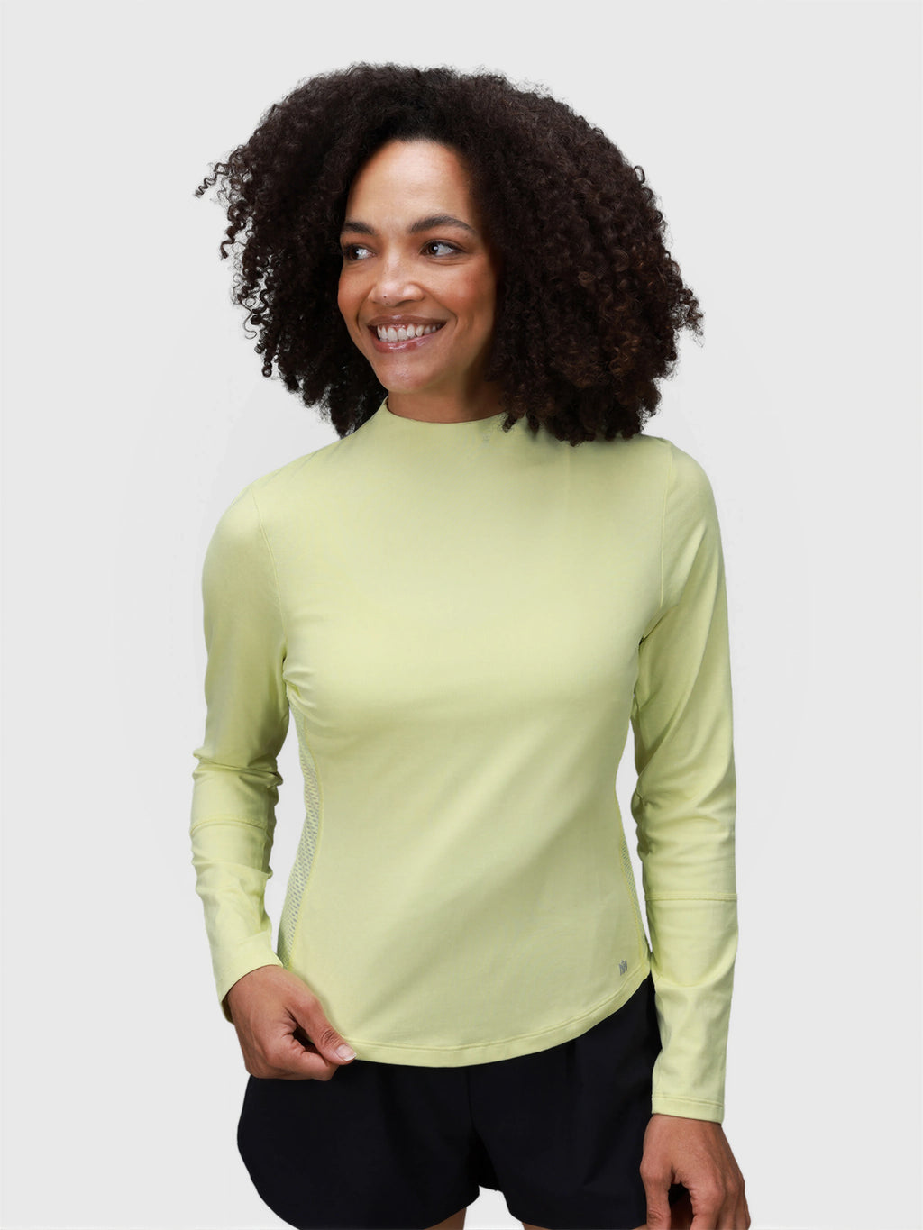 Woman wearing citron AirForm Mesh Back Long Sleeve by MUEV designed for padel and pickleball clothing