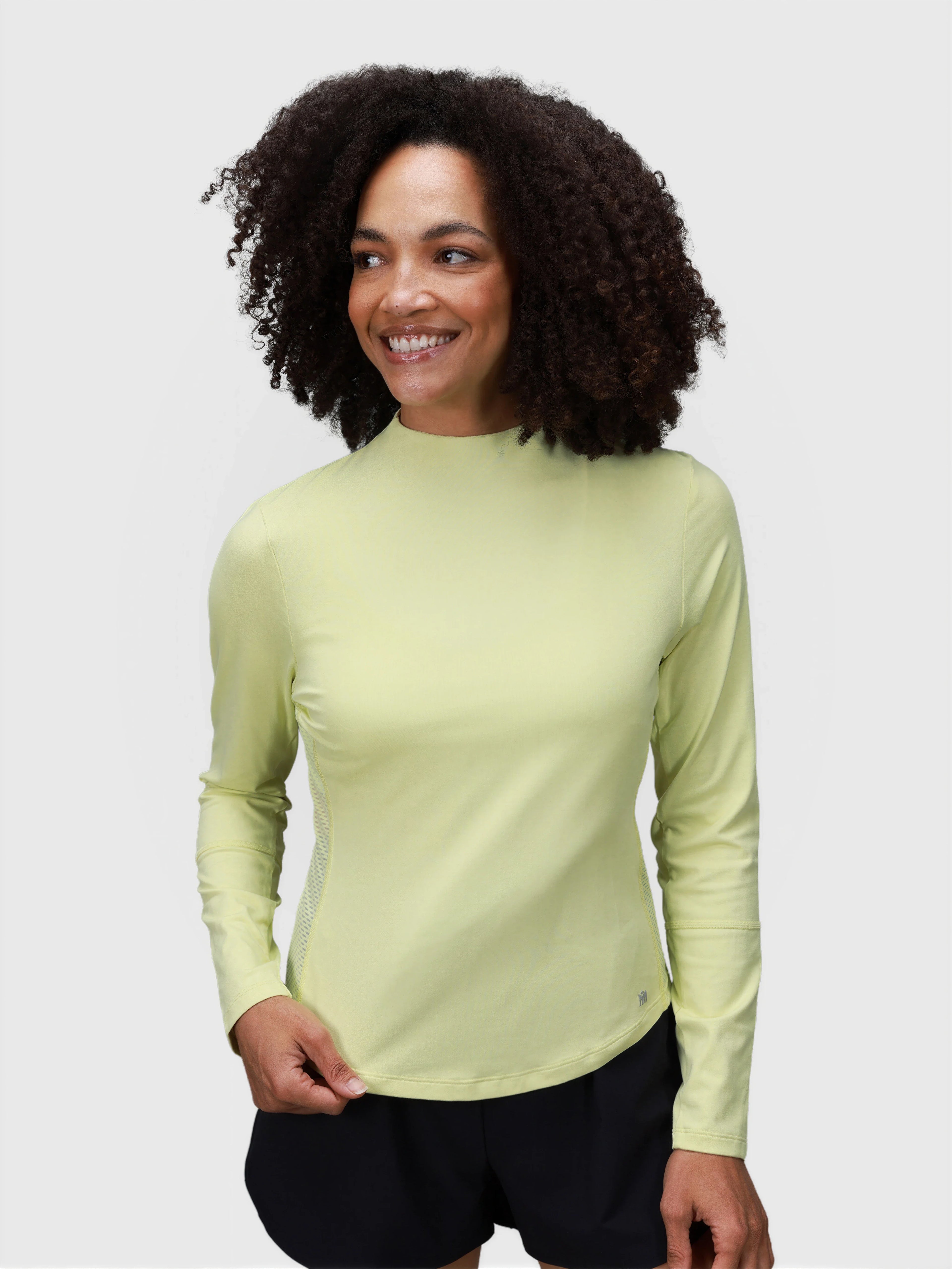 Woman wearing citron AirForm Mesh Back Long Sleeve by MUEV designed for padel and pickleball clothing