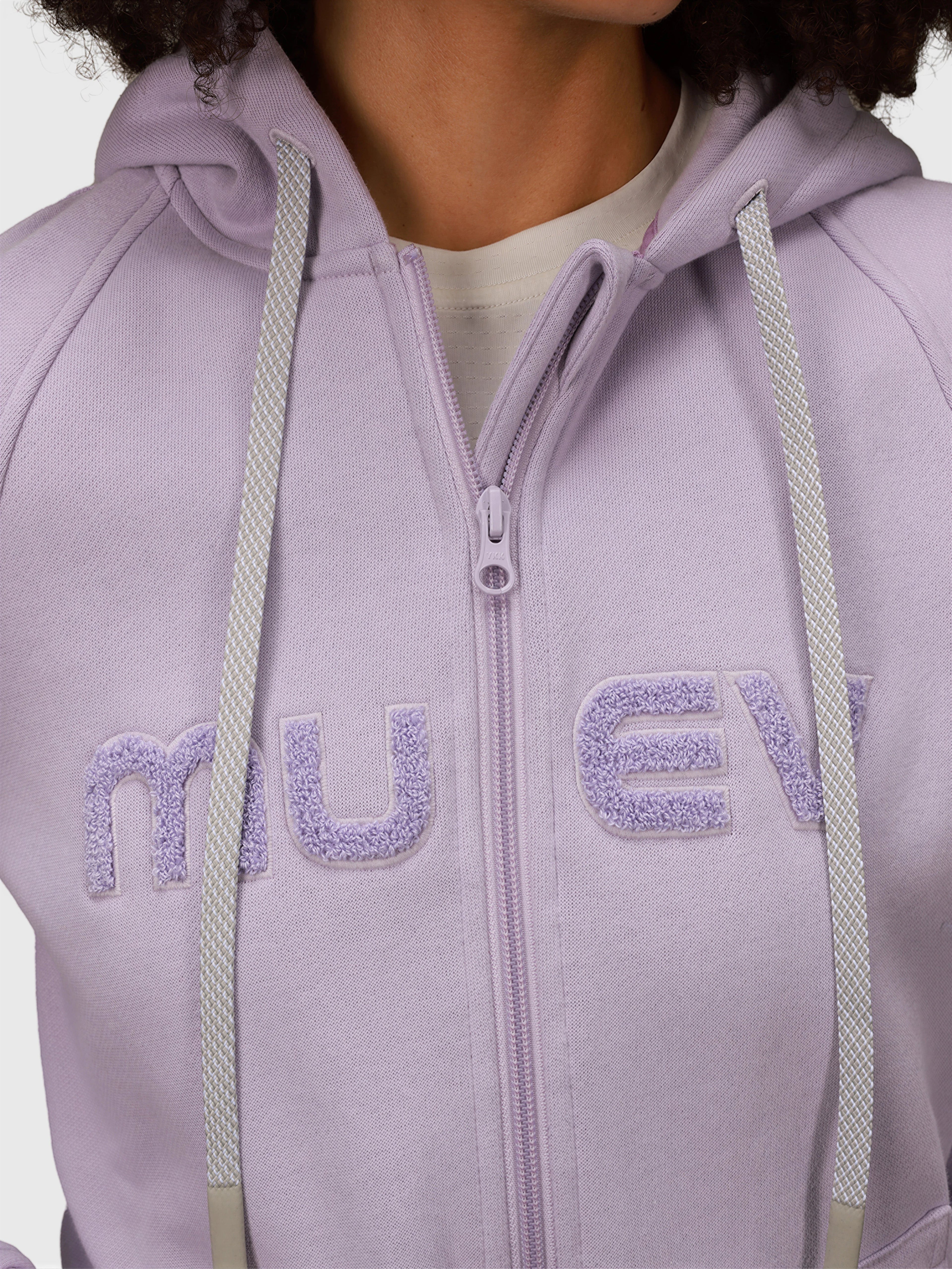 Close-up of lilac Women's Off Court Full Zip Hoodie by MUEV featuring textured logo and drawstring details for padel apparel
